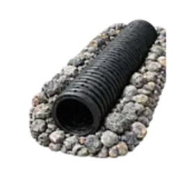 A perforated drain pipe resting in a bed of drainage gravel.